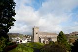 View between trees of Hawkshead Church in the picturesque village of Hawkshead in the Lake District in Cumbria